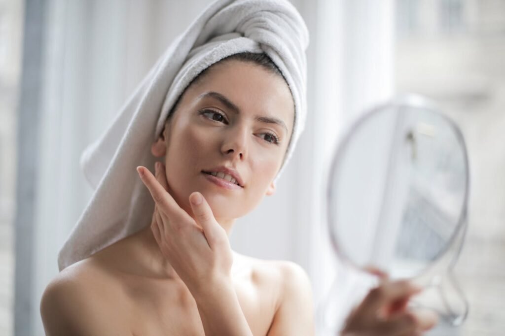 Root Causes of Hormonal Acne: Why Adult Acne Doesn’t Clear and How Holistic Healing Works 9 A beautiful girl with a mirror