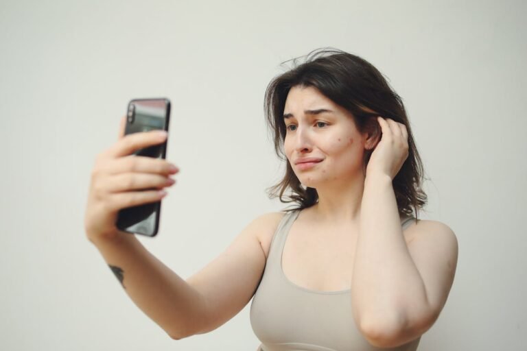 A girl watching herself on a phone